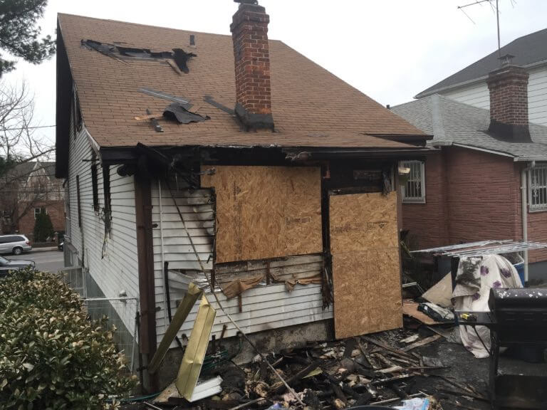 view of damaged exterior to home from fire damage