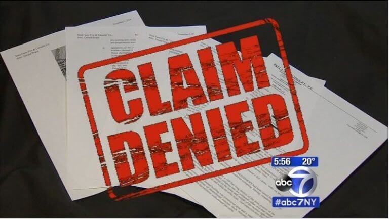 Image of words "Claim Denied" over forms