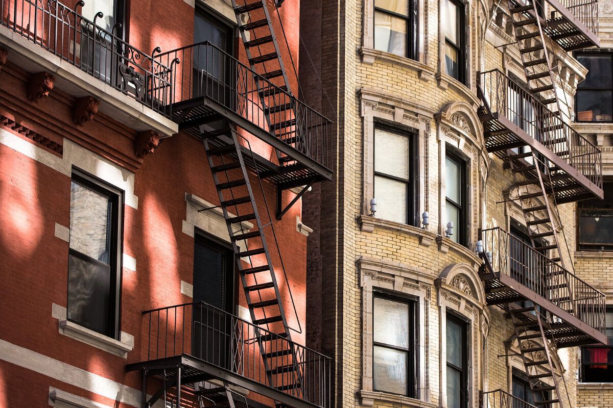 Old apartment building with fire escapes, Manhattan, New York City