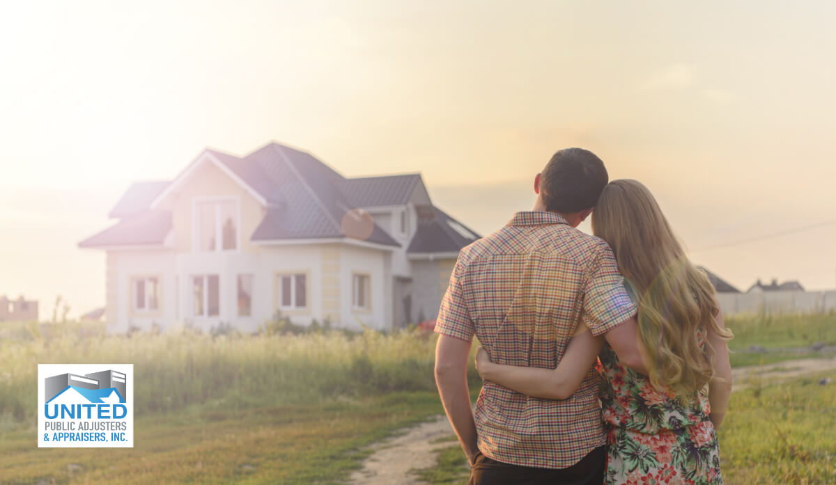 Rear View Of Young Couple,Looking At Their New House